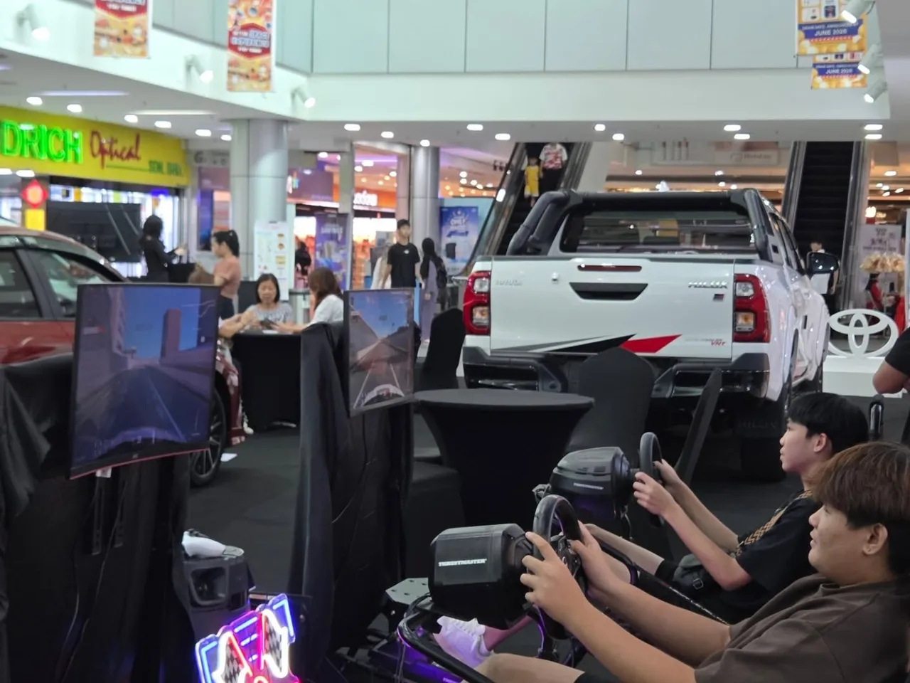 Players racing on sim rigs at the Toyota showroom activation