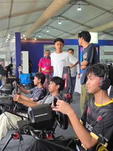 Multiple sim racing rigs running at a public event in Kota Kinabalu